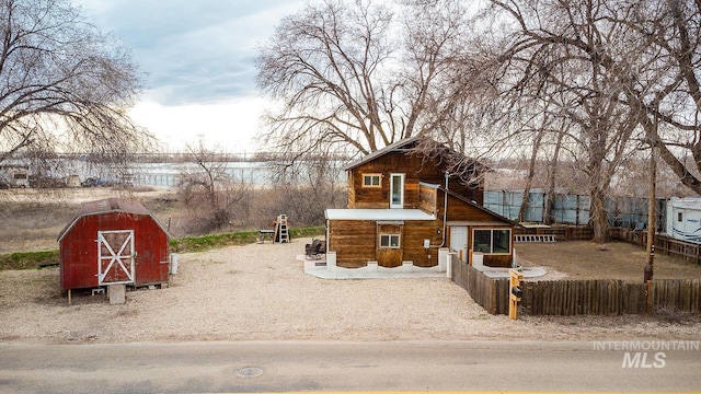 exterior space featuring an outbuilding and fence