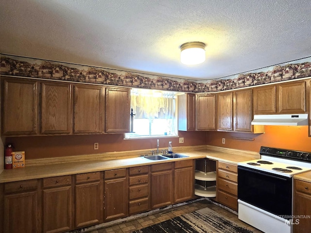 495 1st St E, Huntington, OR 97907 - kitchen featuring range with electric cooktop, under cabinet range hood, a sink, light countertops, and a textured ceiling