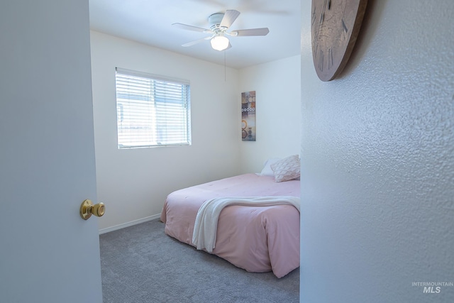 bedroom featuring baseboards, a ceiling fan, and carpet flooring
