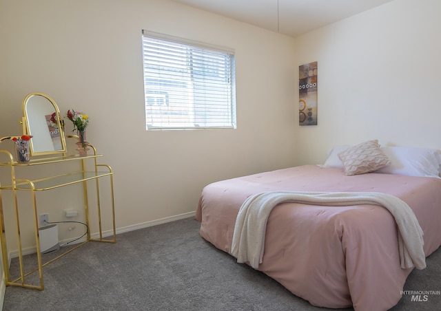 carpeted bedroom featuring baseboards