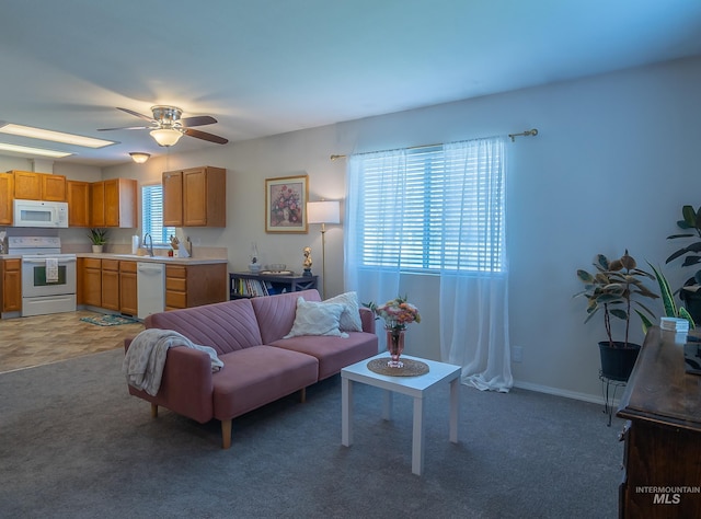 carpeted living area featuring ceiling fan