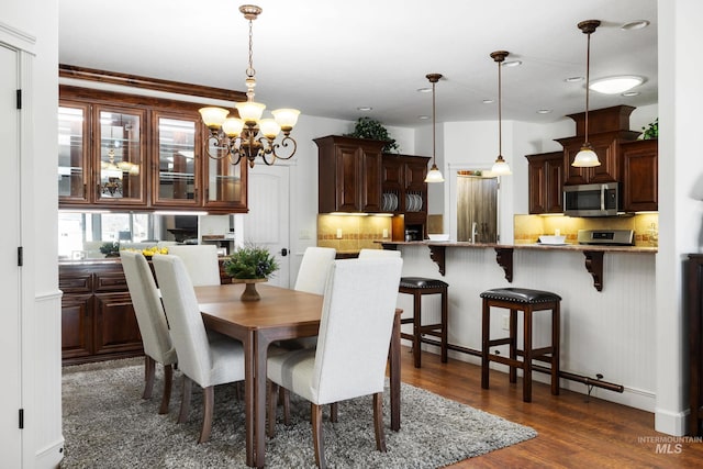 dining space featuring a chandelier and dark wood-style flooring