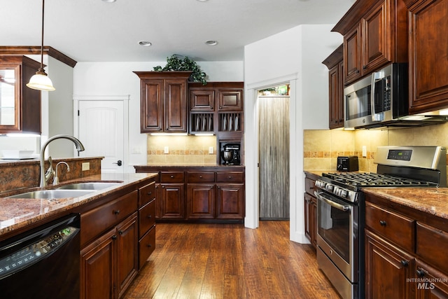 kitchen with stainless steel appliances, dark wood-type flooring, a sink, and tasteful backsplash