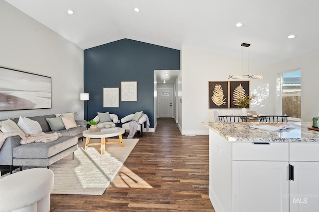 living room with dark hardwood / wood-style flooring and vaulted ceiling