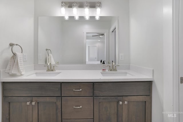 full bathroom featuring double vanity and a ceiling fan