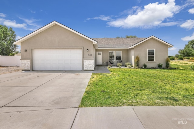 single story home featuring stucco siding, driveway, an attached garage, and stone siding