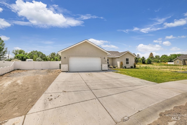view of front of property with concrete driveway, a garage, and stucco siding