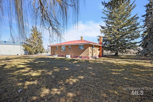 rear view of property with a yard