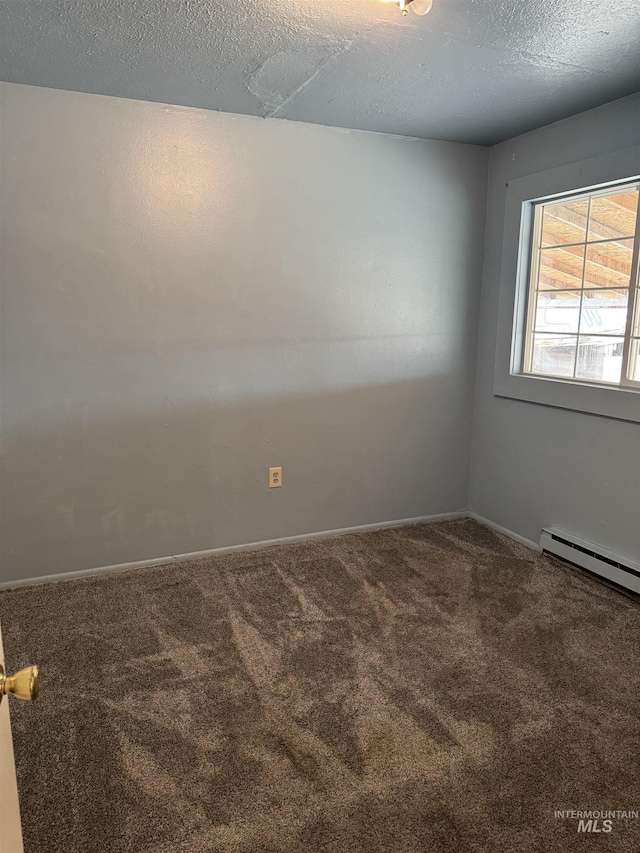1850 18th Circle Dr, Heyburn, ID 83336 - carpeted spare room with a baseboard radiator, baseboards, and a textured ceiling