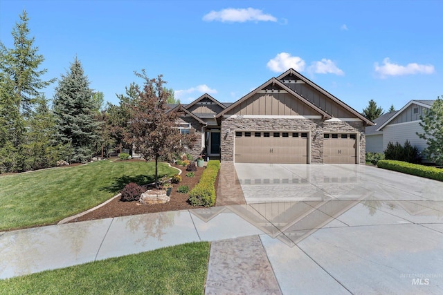 craftsman house featuring board and batten siding, an attached garage, concrete driveway, a front lawn, and stone siding