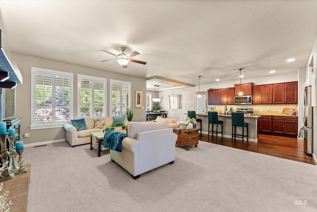 living room with dark carpet, baseboards, ceiling fan, and recessed lighting