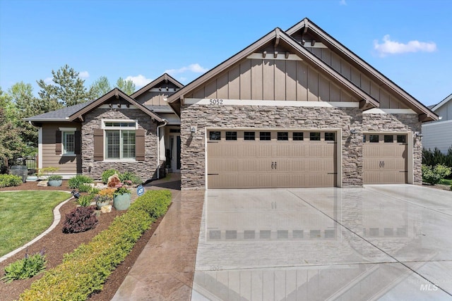 craftsman-style home featuring board and batten siding, an attached garage, and stone siding