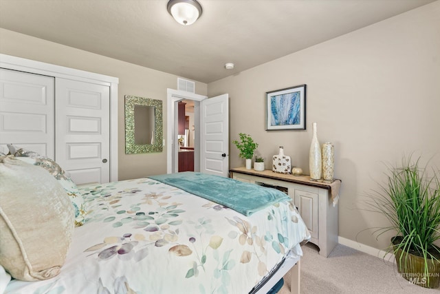 bedroom with light colored carpet, baseboards, and a closet