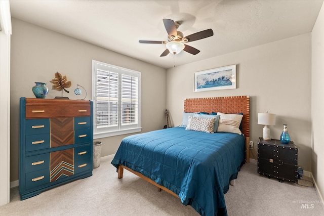 carpeted bedroom featuring baseboards and ceiling fan