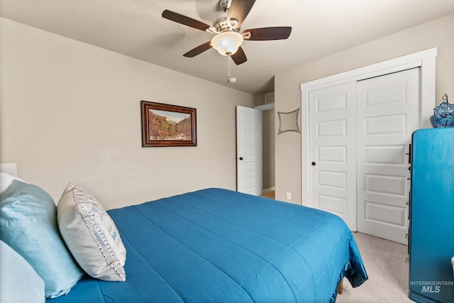 carpeted bedroom with a closet and a ceiling fan