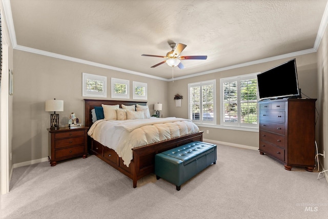 bedroom featuring baseboards, light colored carpet, ornamental molding, ceiling fan, and a textured ceiling