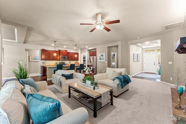 living area with recessed lighting, ceiling fan, and baseboards