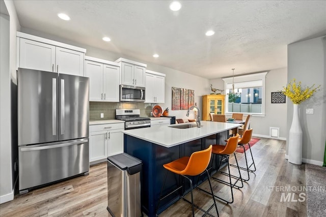 4084 E Esperanto St, Meridian, ID 83642 - kitchen featuring light wood-style flooring, a sink, backsplash, and stainless steel appliances