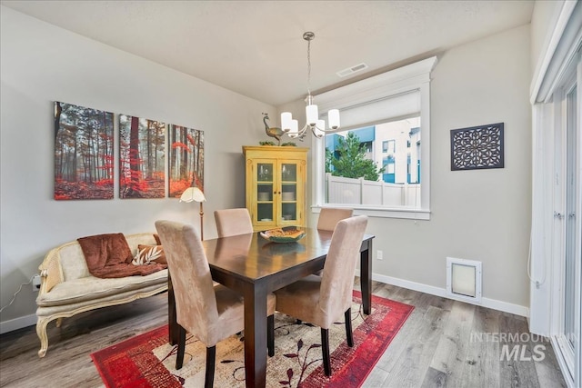 4084 E Esperanto St, Meridian, ID 83642 - dining space featuring wood finished floors, visible vents, a notable chandelier, and baseboards