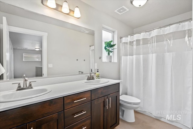 4084 E Esperanto St, Meridian, ID 83642 - bathroom featuring toilet, double vanity, a sink, and visible vents