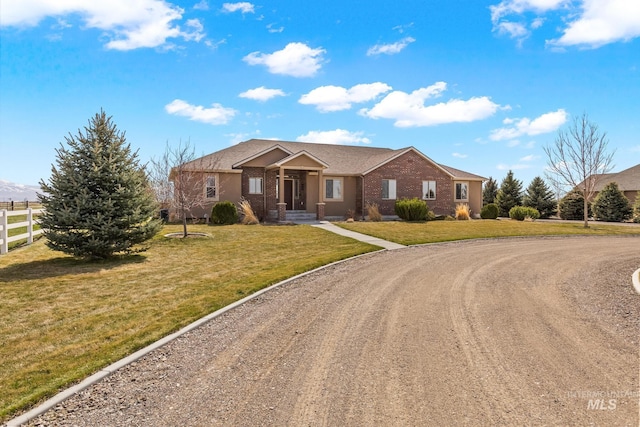 11 W 300 S, Burley, ID 83318 - single story home featuring brick siding, fence, curved driveway, and a front yard