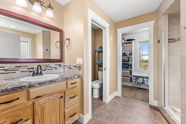 11 W 300 S, Burley, ID 83318 - bathroom with a tile shower, tile patterned flooring, toilet, vanity, and baseboards