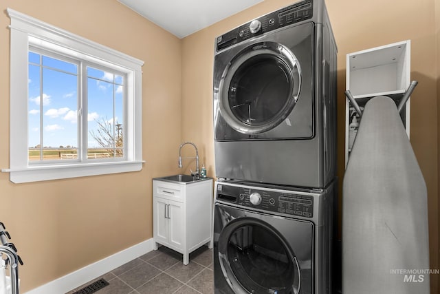 11 W 300 S, Burley, ID 83318 - laundry room featuring a sink, visible vents, baseboards, cabinet space, and stacked washing maching and dryer
