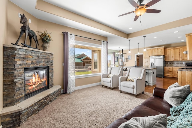 11 W 300 S, Burley, ID 83318 - living room featuring baseboards, recessed lighting, light colored carpet, a ceiling fan, and a fireplace
