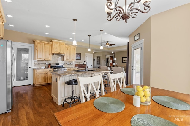 11 W 300 S, Burley, ID 83318 - kitchen with light brown cabinetry, a sink, under cabinet range hood, an island with sink, and appliances with stainless steel finishes