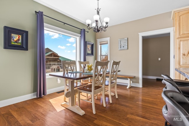 11 W 300 S, Burley, ID 83318 - dining area featuring dark wood-type flooring, baseboards, and an inviting chandelier