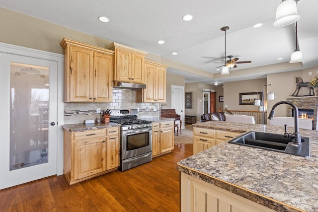 11 W 300 S, Burley, ID 83318 - kitchen with light brown cabinetry, a sink, stainless steel gas range, ceiling fan, and under cabinet range hood