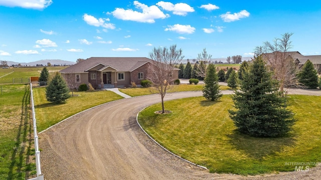 11 W 300 S, Burley, ID 83318 - single story home with a front lawn, fence, a mountain view, and curved driveway