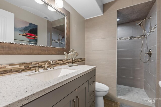 11 W 300 S, Burley, ID 83318 - full bath with a tile shower, toilet, vanity, and tile patterned floors