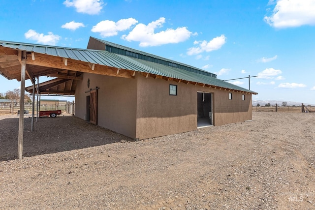 11 W 300 S, Burley, ID 83318 - rear view of house with driveway, an outdoor structure, an attached carport, an exterior structure, and metal roof