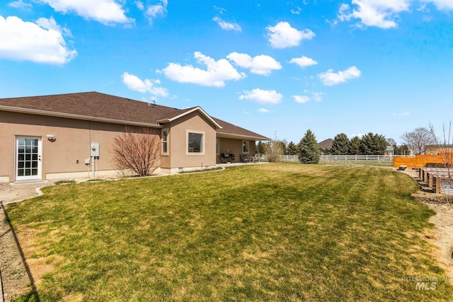 11 W 300 S, Burley, ID 83318 - rear view of house featuring fence, a yard, and stucco siding