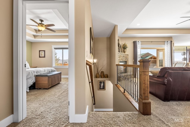 11 W 300 S, Burley, ID 83318 - hall with a tray ceiling, carpet flooring, baseboards, and an upstairs landing