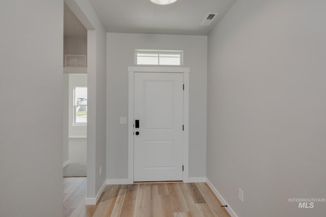 entrance foyer with light wood-style floors, visible vents, and baseboards