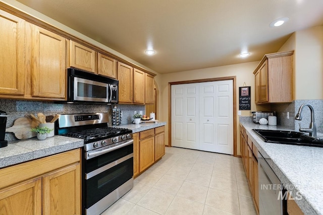 992 N Pinnacle, Eagle, ID 83616 - kitchen featuring appliances with stainless steel finishes, a sink, tasteful backsplash, light tile patterned floors, and recessed lighting