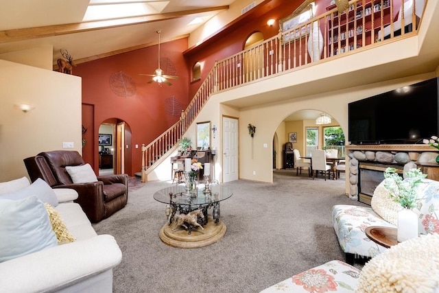 992 N Pinnacle, Eagle, ID 83616 - carpeted living room featuring arched walkways, high vaulted ceiling, stairs, ceiling fan, and beam ceiling