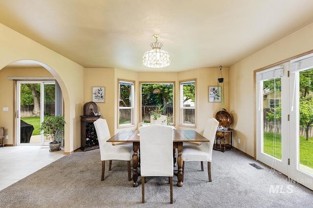 992 N Pinnacle, Eagle, ID 83616 - carpeted dining room with healthy amount of natural light, arched walkways, a chandelier, and baseboards