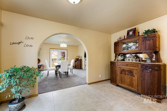 992 N Pinnacle, Eagle, ID 83616 - dining area featuring arched walkways, light carpet, light tile patterned floors, and baseboards