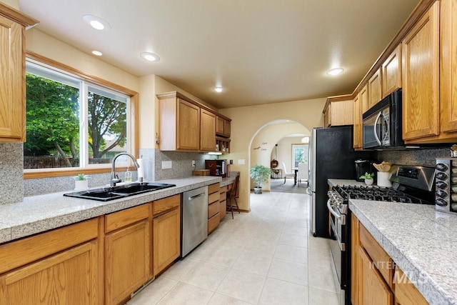 992 N Pinnacle, Eagle, ID 83616 - kitchen featuring appliances with stainless steel finishes, tile counters, a sink, backsplash, and recessed lighting