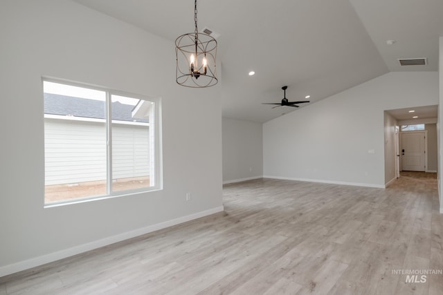 unfurnished room featuring lofted ceiling, a healthy amount of sunlight, light wood-type flooring, and visible vents