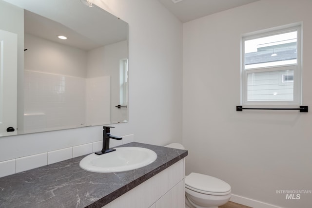 bathroom featuring toilet and vanity