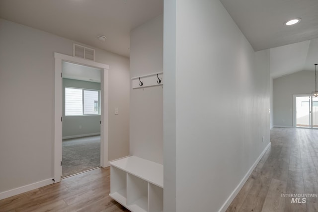 interior space with light wood-type flooring, visible vents, baseboards, vaulted ceiling, and recessed lighting