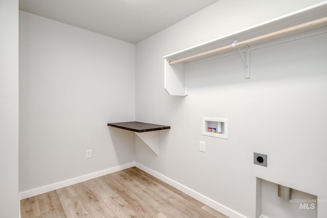 laundry area featuring laundry area, light wood-style flooring, electric dryer hookup, baseboards, and hookup for a washing machine