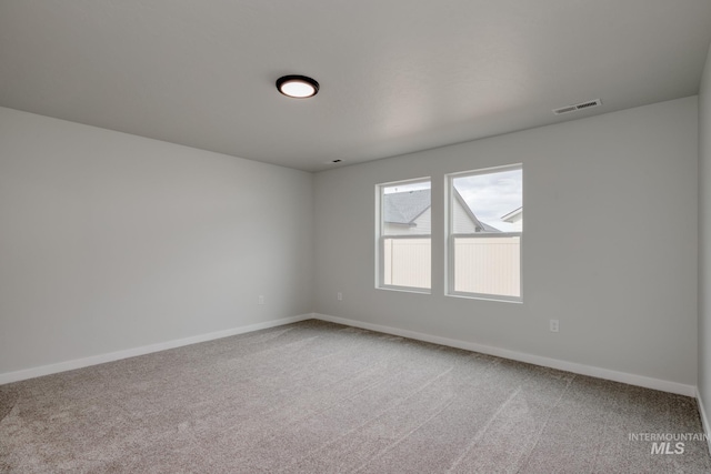 unfurnished room featuring light carpet, baseboards, and visible vents