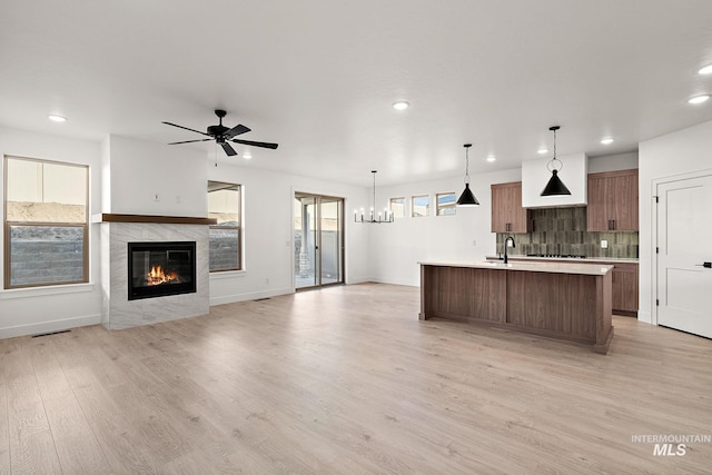 kitchen with visible vents, tasteful backsplash, light wood-type flooring, light countertops, and recessed lighting