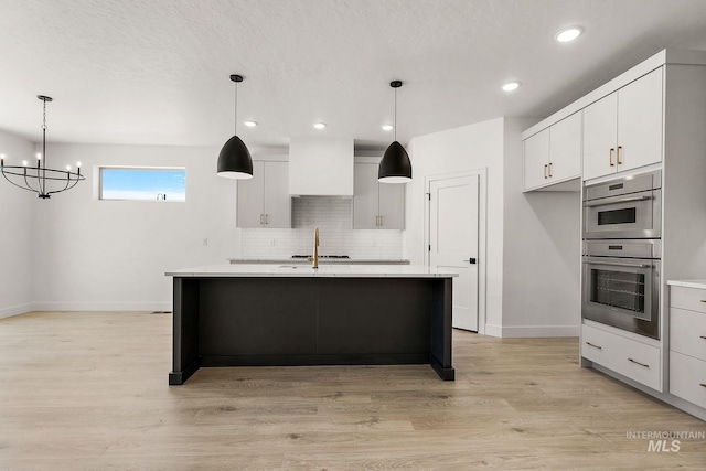 1700 Black Elm, Star, ID 83669 - kitchen with double oven, light countertops, a chandelier, backsplash, and light wood-style flooring
