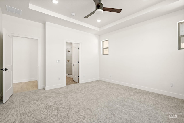 1700 Black Elm, Star, ID 83669 - unfurnished bedroom featuring recessed lighting, a tray ceiling, carpet flooring, ceiling fan, and connected bathroom
